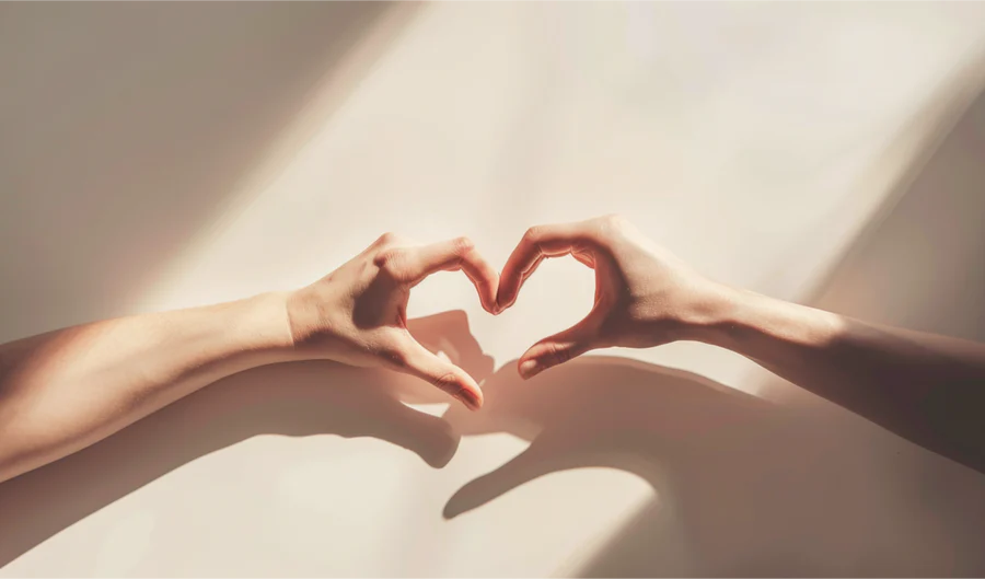 heartshaped-shadow-two-hands-forming-symbol-love-white-background_4.webp